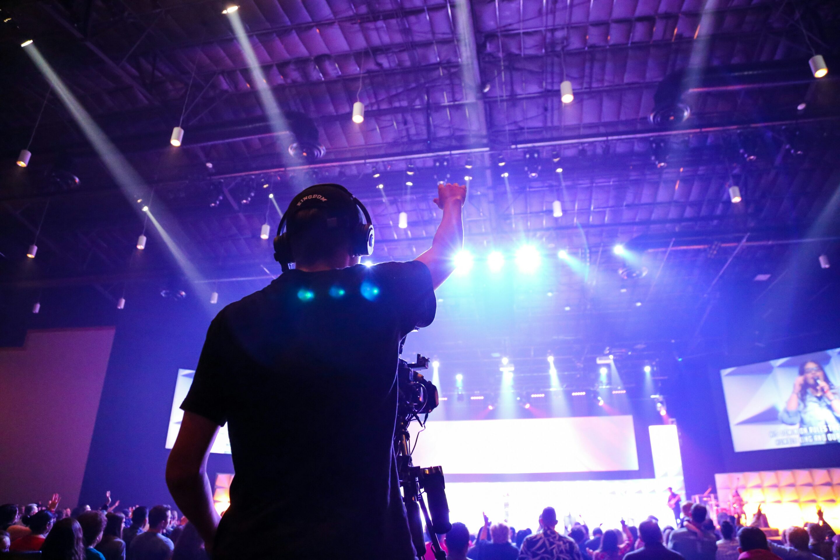 media team volunteer raising hand in worship